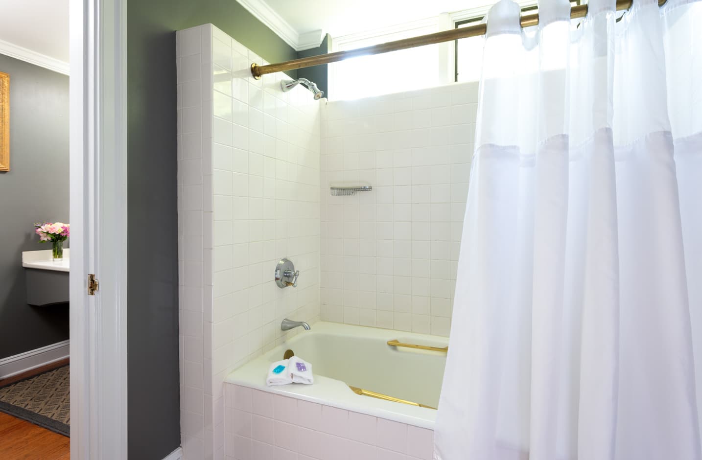 A bathroom with a shower and tub combo