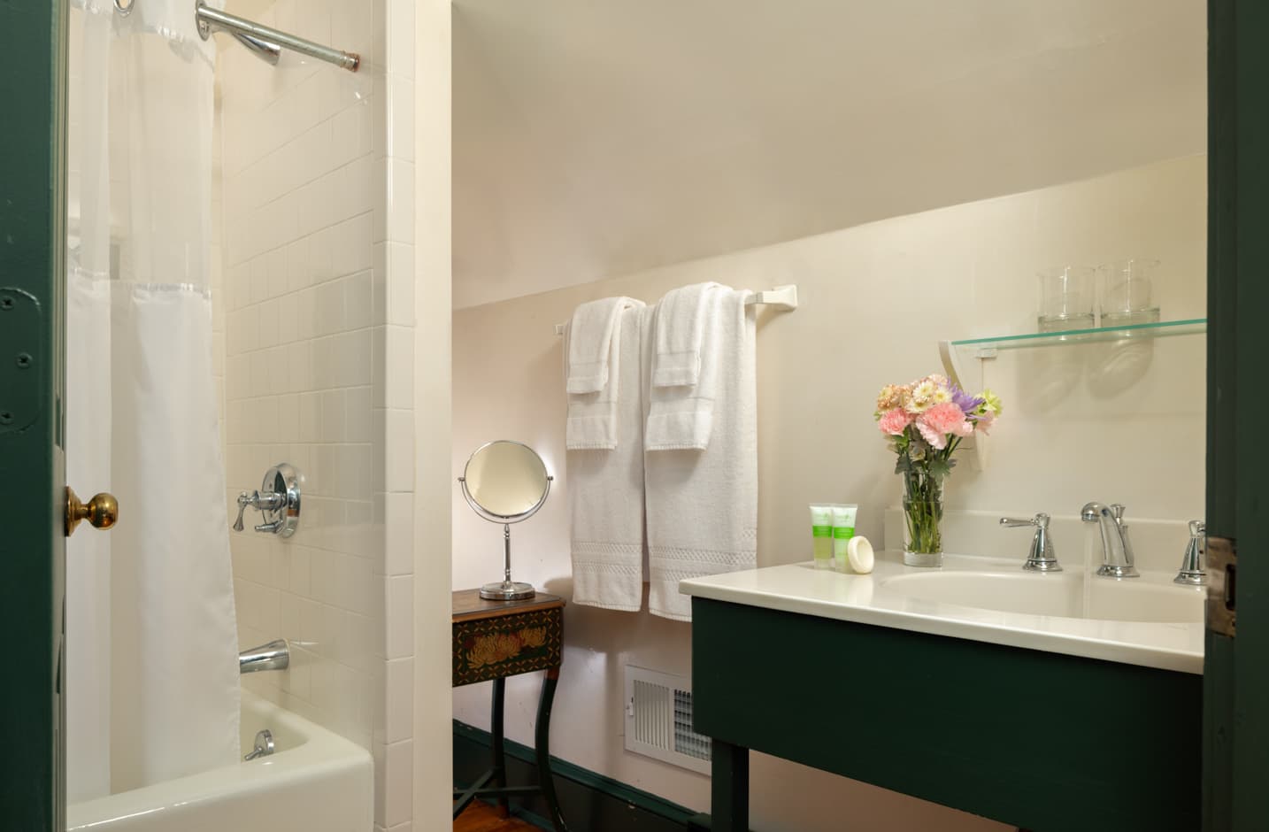 A full private bathroom with a shower and tub combo