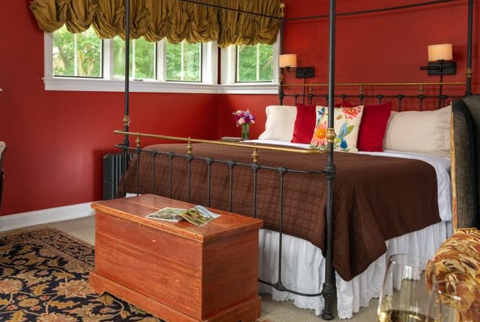 Wrought iron king bed in a room with country furnishing