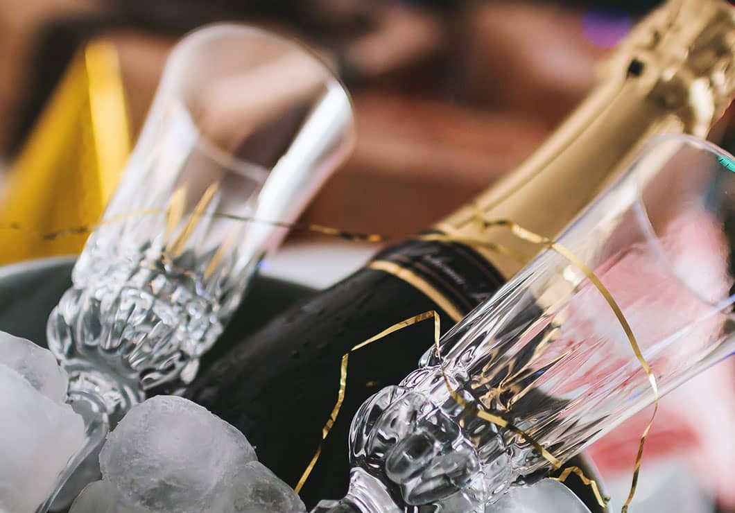 Champagne bottle in ice with two Champagne flutes