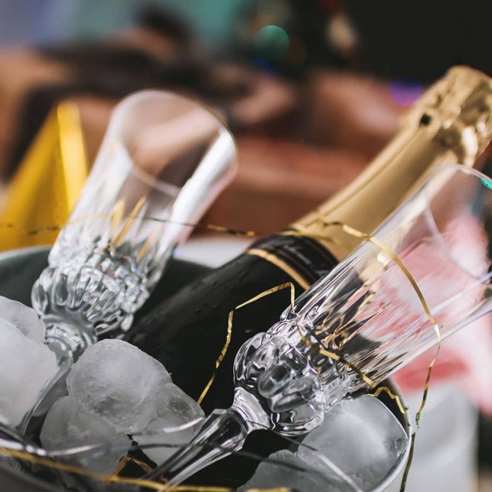 Champagne bottle in ice with two Champagne flutes