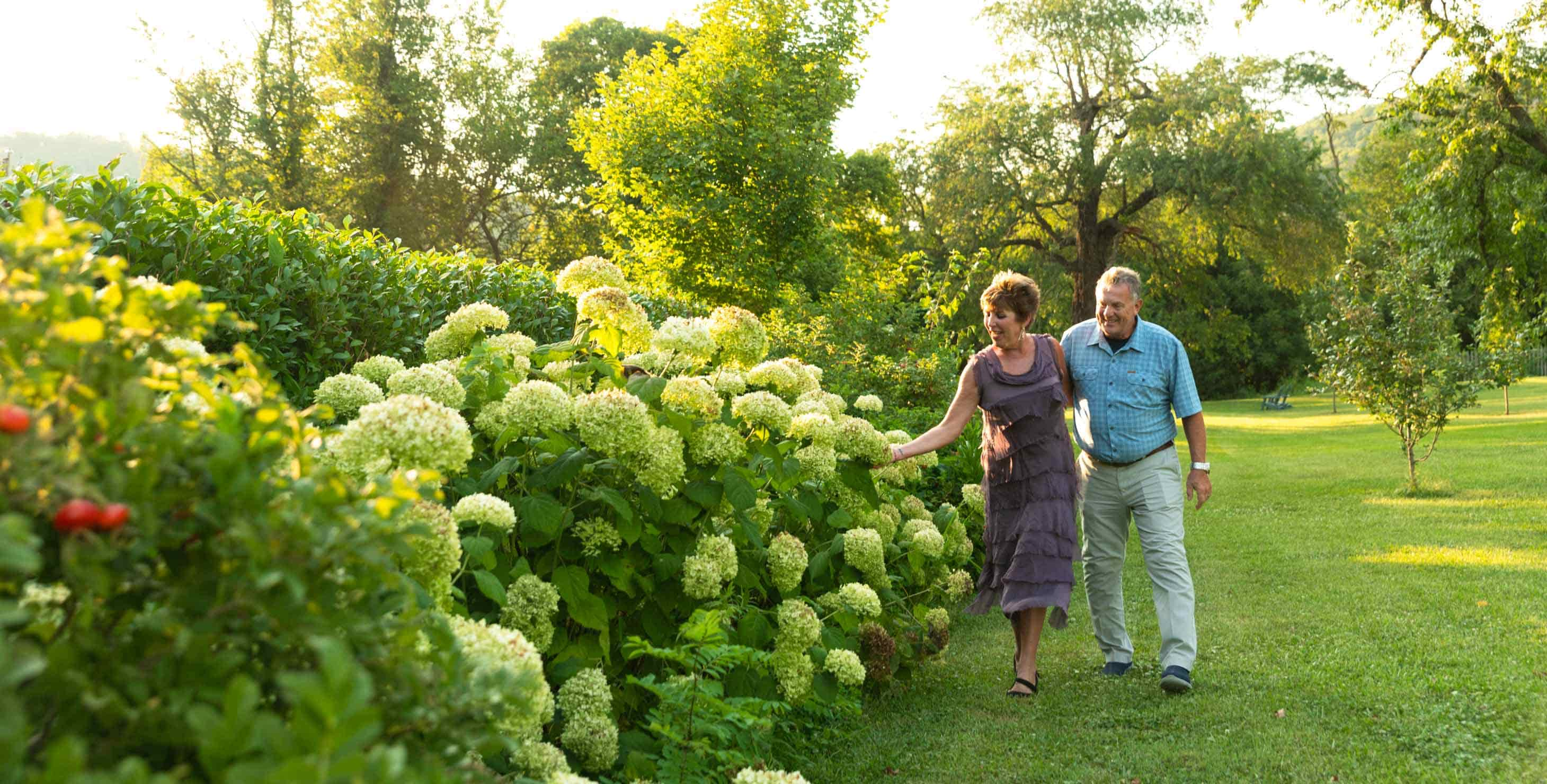 Couple walking in the garden in the afternoon