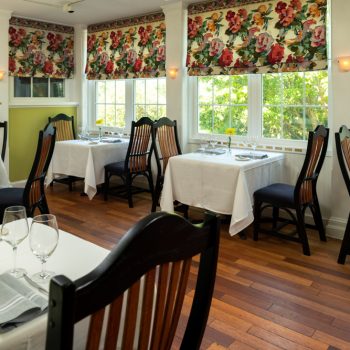 Interior of Ashby Inn & Restaurant with tables near a wall of windows