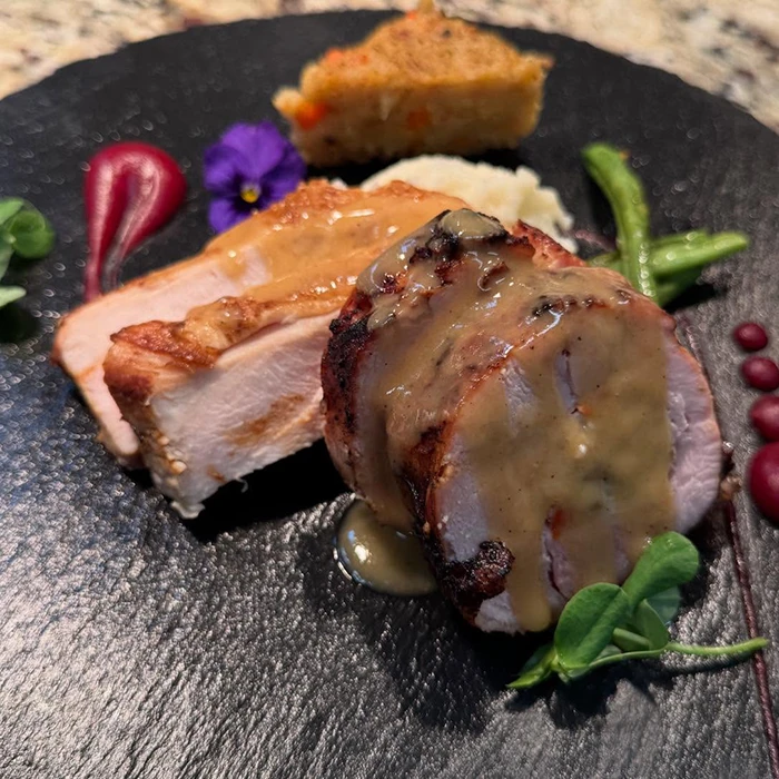 Beautifully presented dinner on black plate - The Ashby Inn Fine Dining Restaurant in Paris VA